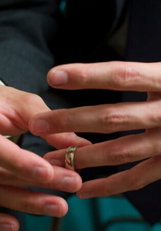 Man removing his gold wedding ring as a sign that he is getting a divorce.